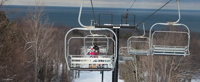 Author's daughter and wife riding the lift at Porcupine Mountains Ski Area.