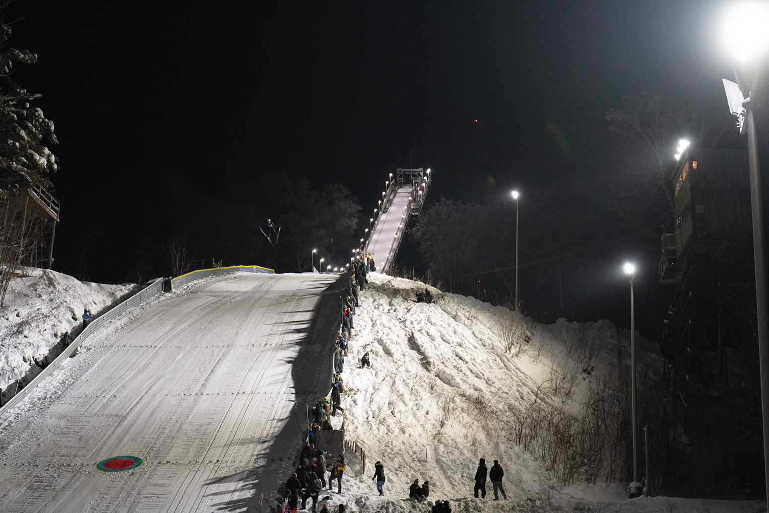 “The target event at the 136th annual ski jump on Suicide Hill put on by Ishpeming Ski Club. Ski jumping has been a tradition in the Upper Peninsula since the late 1800s. Originally brought here by Norwegian immigrants, the tradition stands today. In the target event skiers try to land as close as possible to the target painted in the landing zone.”  Photo: Kyle Bolen